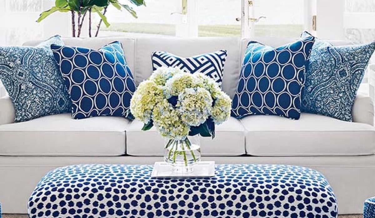 Blue custom throw pillows arranged on a sofa