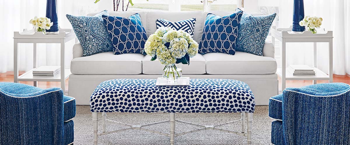 Custom pillows, upholstered seating and soft treatments styled in a living room